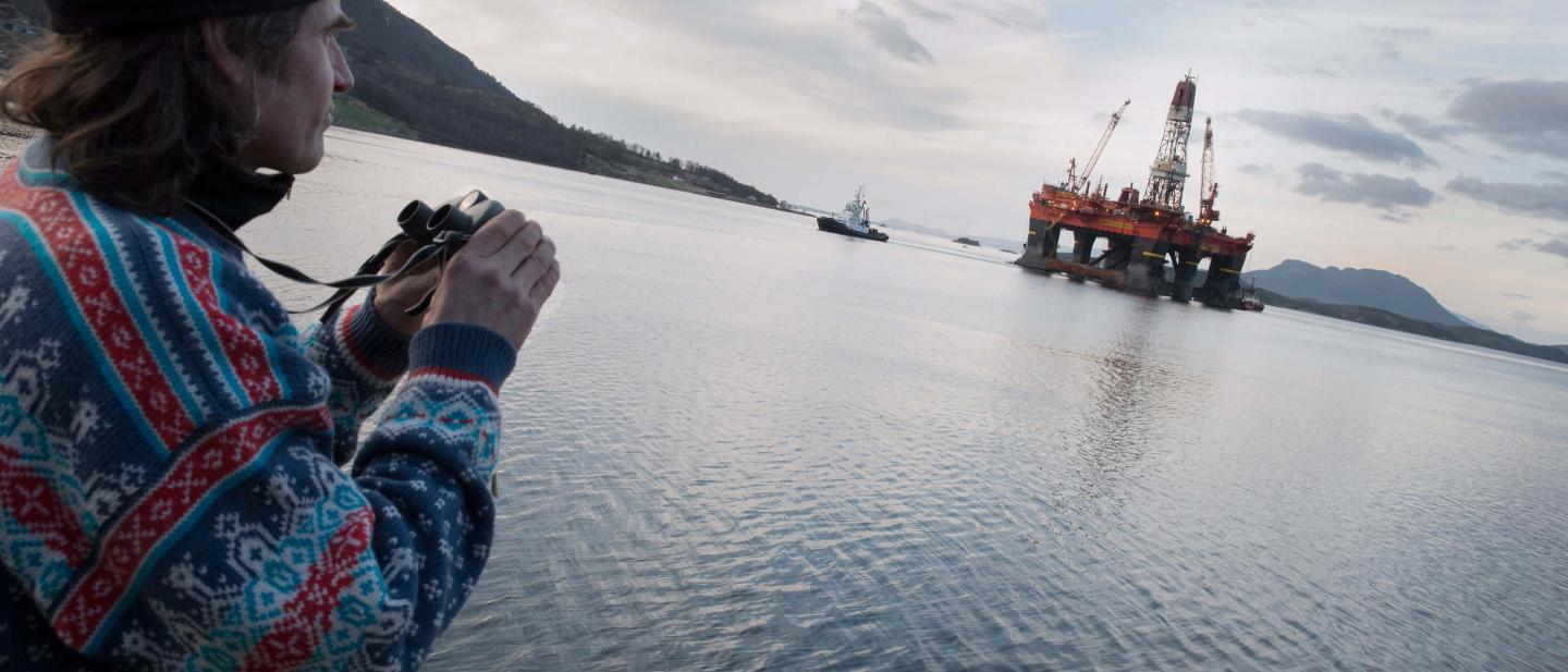 man looking at oil rig
